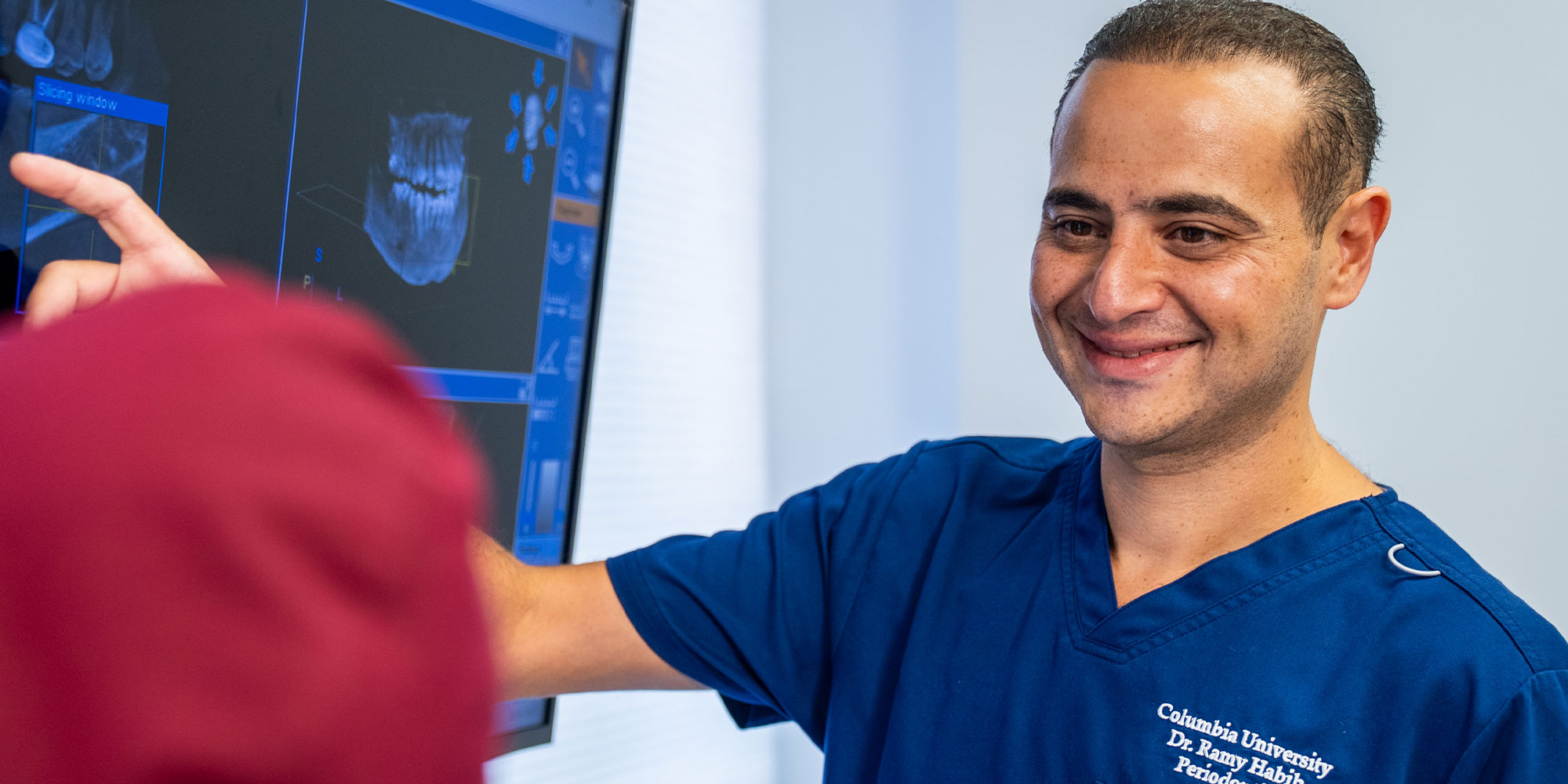 doctor smiling and going over treatment information with fellow doctor