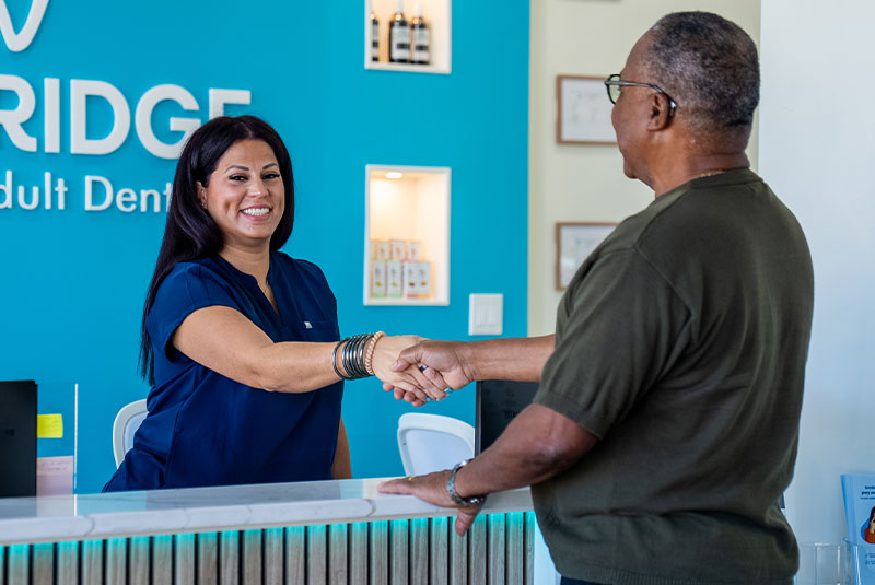 Dentist holding tools, smiling