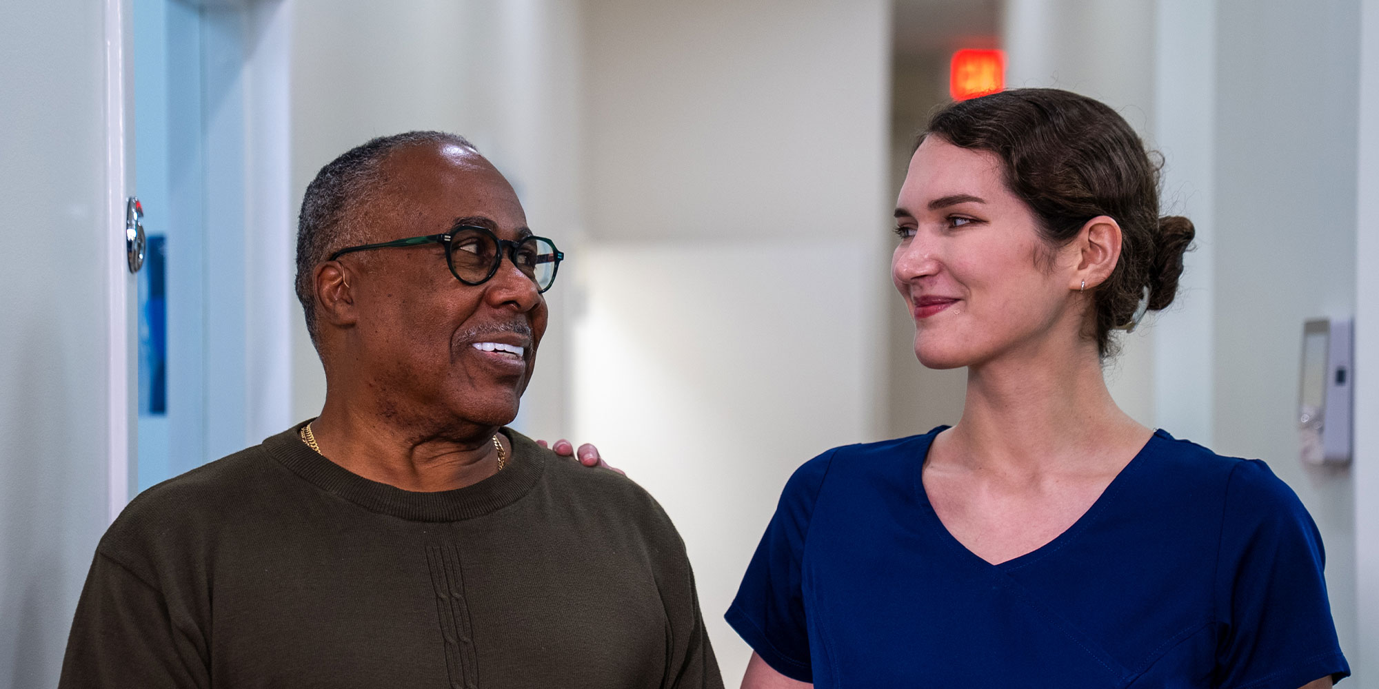 patient and staff member walking down the hall of the dental center