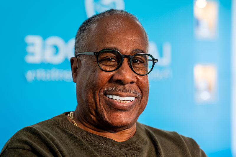 headshot of patient smiling brightly after their dental procedure