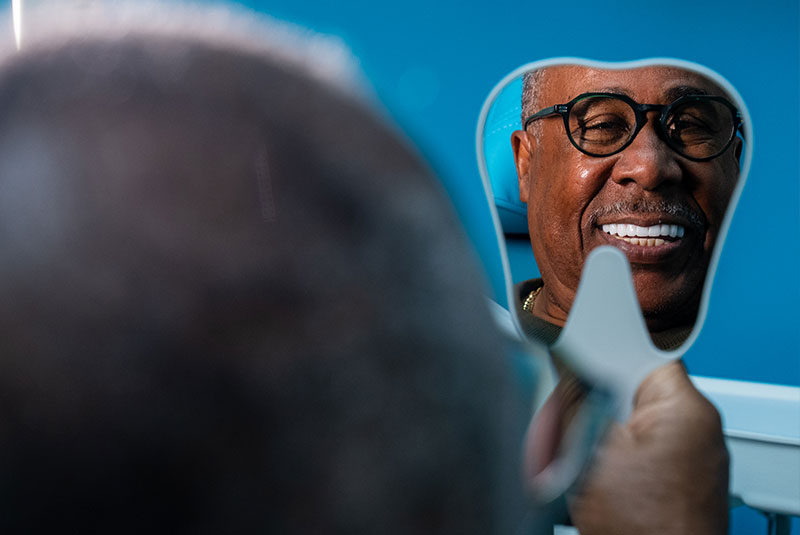 patient smiling brightly after their dental implant procedure